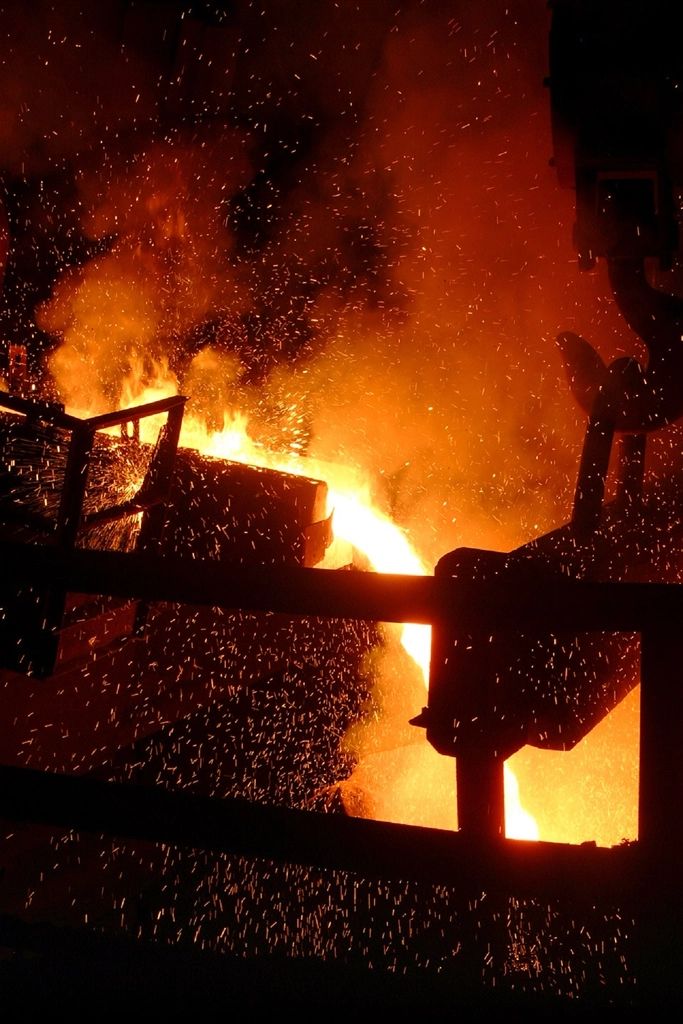 Molten steel glowing orange inside an industrial furnace